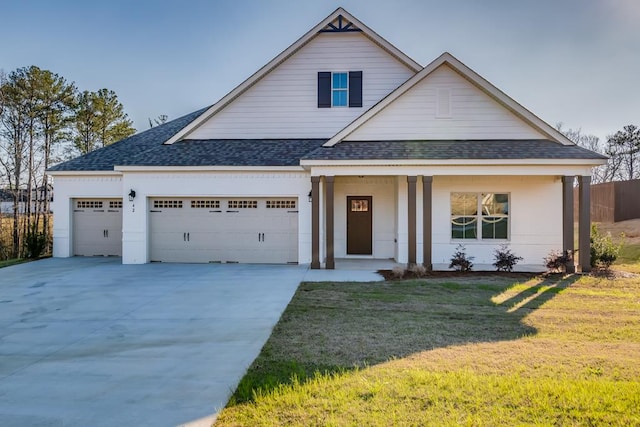 view of front of house featuring a front lawn and a garage