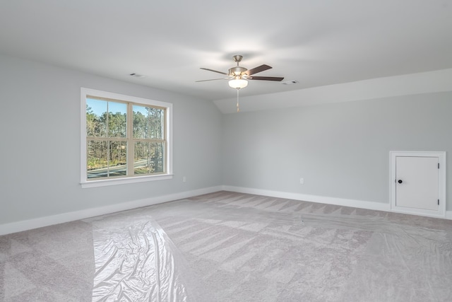 unfurnished room with ceiling fan, vaulted ceiling, and light carpet