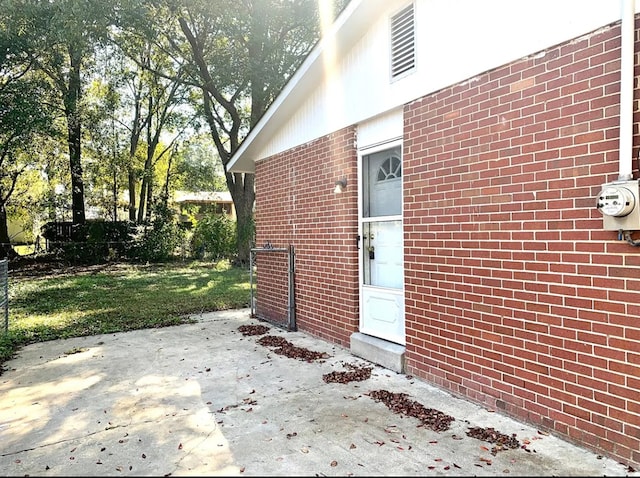 property entrance featuring a patio area and a yard