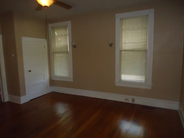 spare room with dark hardwood / wood-style floors and ceiling fan