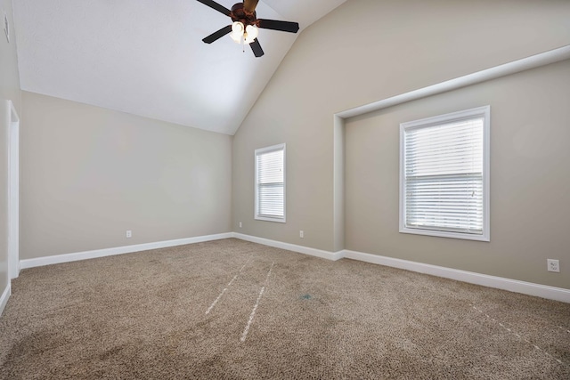 carpeted spare room featuring high vaulted ceiling and ceiling fan