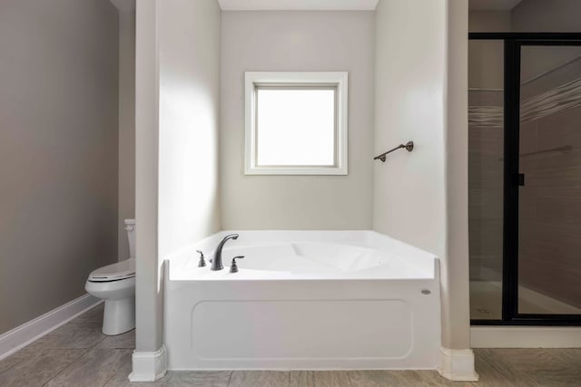 bathroom with shower with separate bathtub and toilet