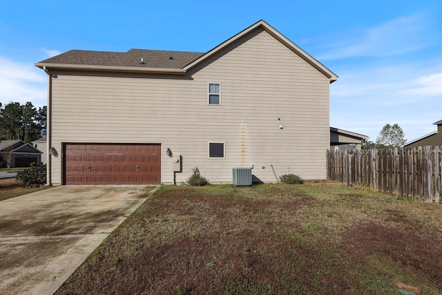 view of home's exterior featuring a yard, a garage, and central air condition unit