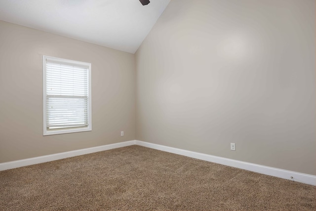 carpeted empty room with lofted ceiling