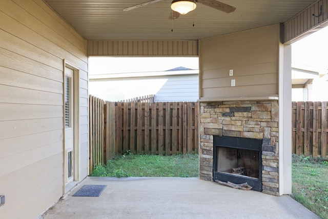 view of patio / terrace with ceiling fan and an outdoor stone fireplace