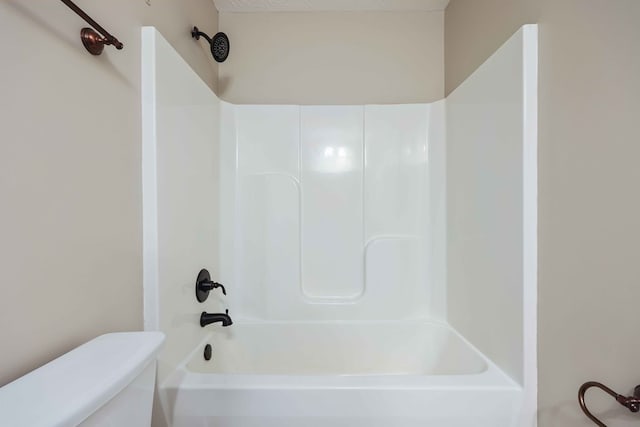 bathroom featuring shower / bath combination and toilet