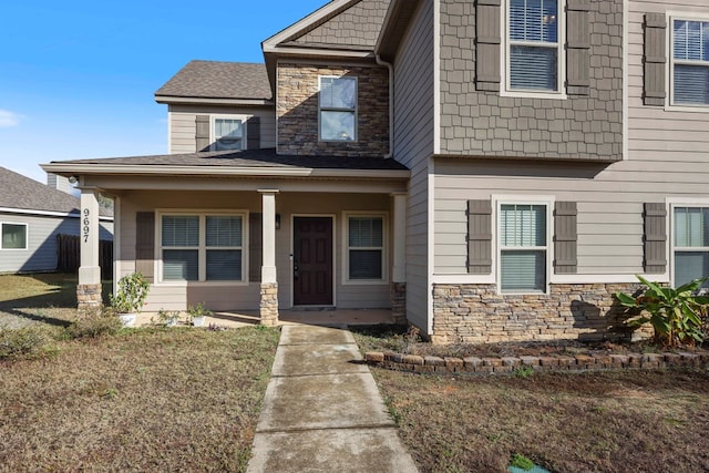 view of front facade featuring covered porch and a front yard