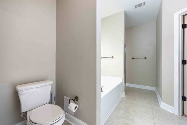 bathroom with a washtub and toilet