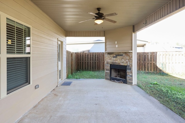 view of patio / terrace with an outdoor stone fireplace and ceiling fan