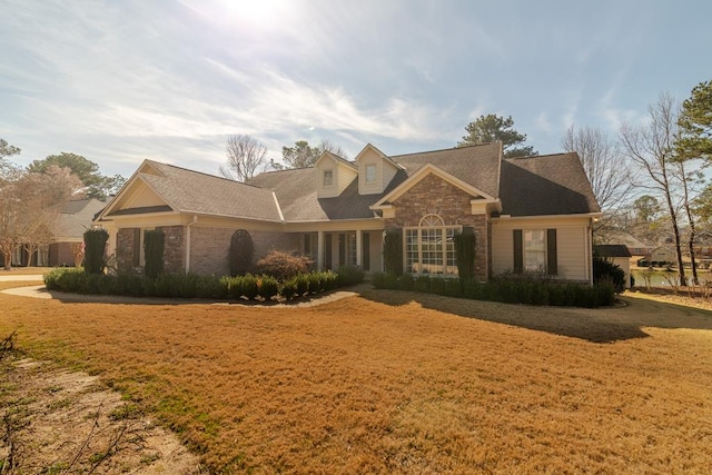 view of front of house with stone siding and a front yard