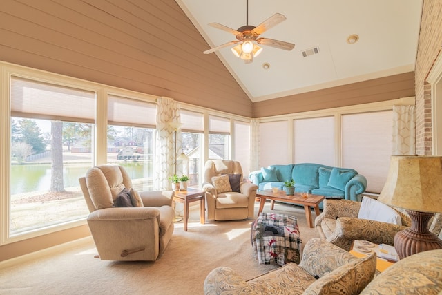 sunroom with a healthy amount of sunlight, visible vents, a ceiling fan, and lofted ceiling