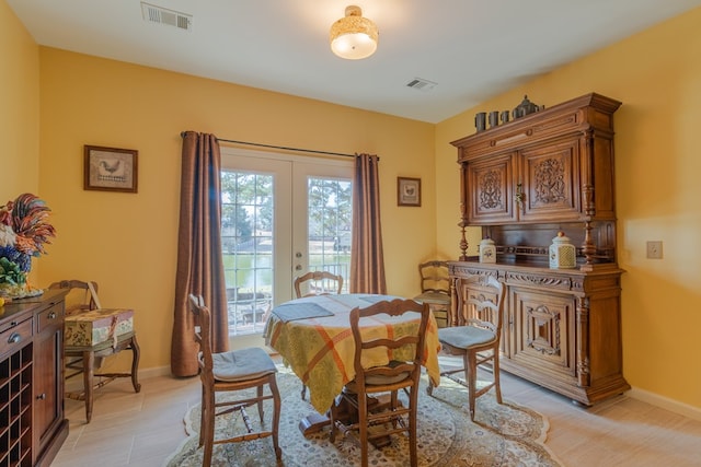 dining room with baseboards, visible vents, and french doors