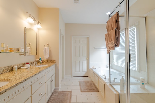 full bathroom featuring a garden tub, double vanity, visible vents, a sink, and tile patterned floors