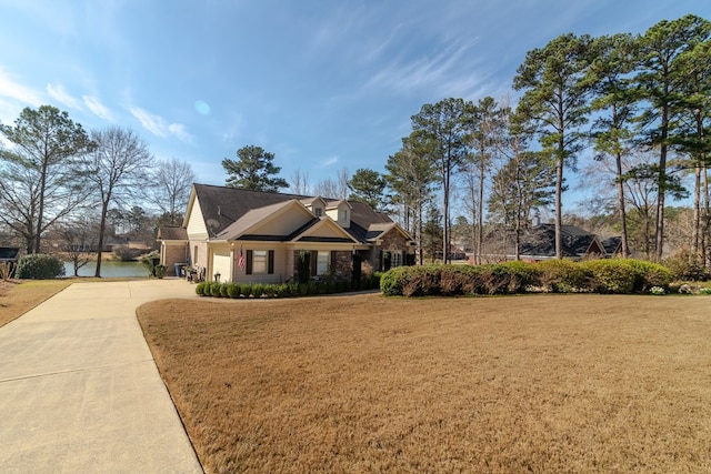 view of front of home with concrete driveway and a front yard