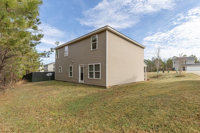 back of property featuring a lawn