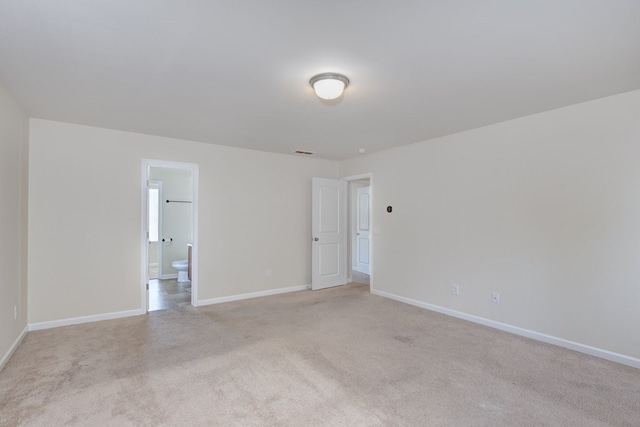 unfurnished room with light colored carpet