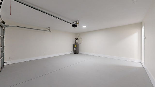 garage with a garage door opener, water heater, and baseboards