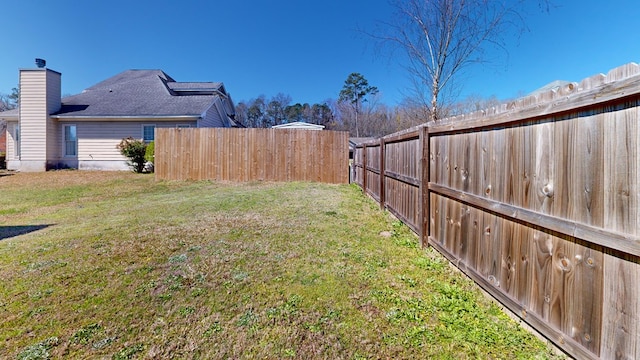 view of yard with a fenced backyard