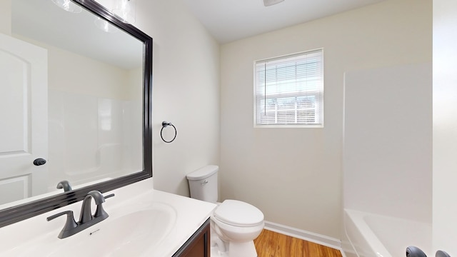 full bath with vanity, toilet, wood finished floors, and baseboards