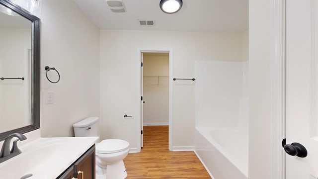 full bathroom featuring visible vents, toilet, wood finished floors, baseboards, and vanity