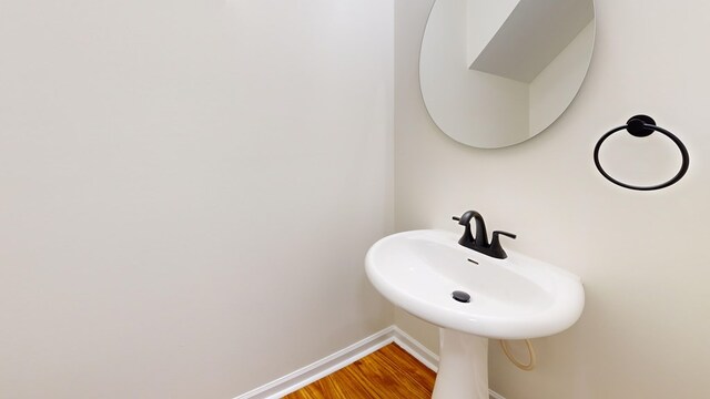 bathroom with wood finished floors and baseboards