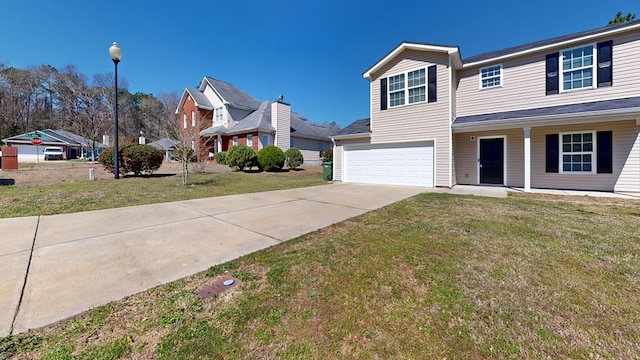 view of front of house featuring a front lawn, a garage, and driveway