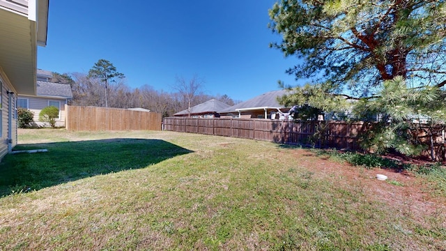 rear view of property with a lawn and fence