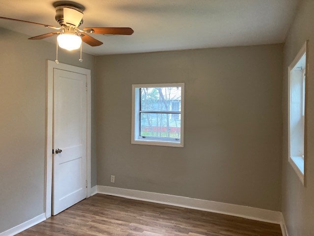 empty room with hardwood / wood-style floors and ceiling fan