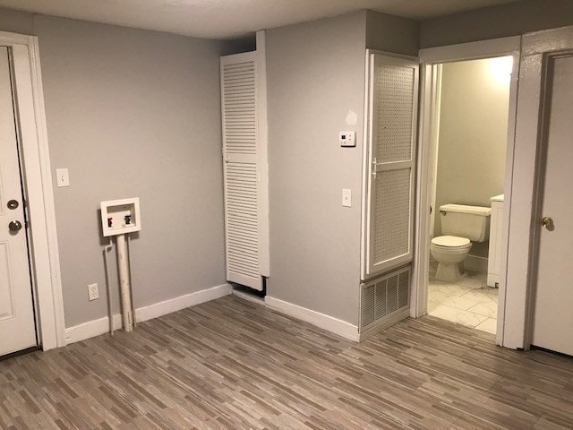 interior space with washer hookup and hardwood / wood-style flooring