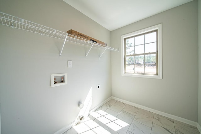 laundry area featuring washer hookup, laundry area, marble finish floor, and baseboards