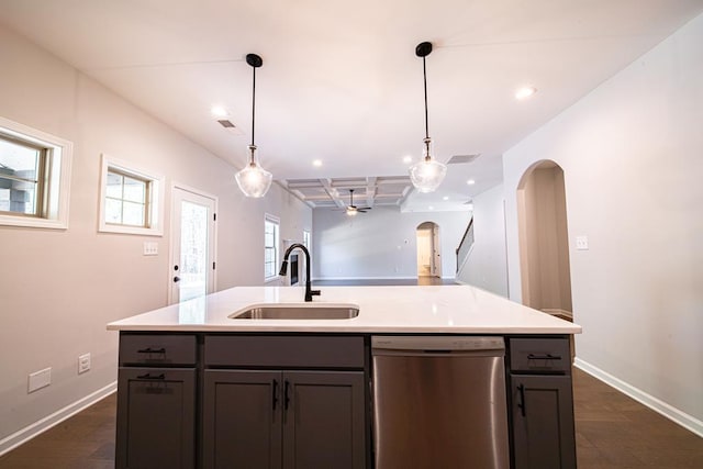 kitchen with arched walkways, coffered ceiling, open floor plan, stainless steel dishwasher, and a sink