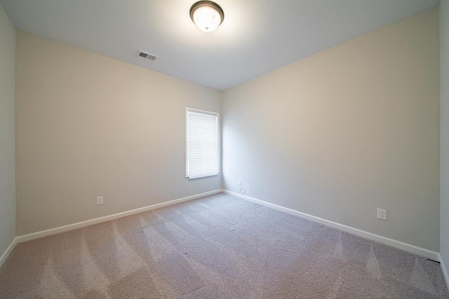 unfurnished room featuring carpet floors, baseboards, and visible vents