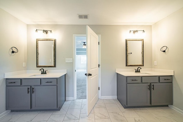 full bathroom featuring marble finish floor, two vanities, a sink, and visible vents