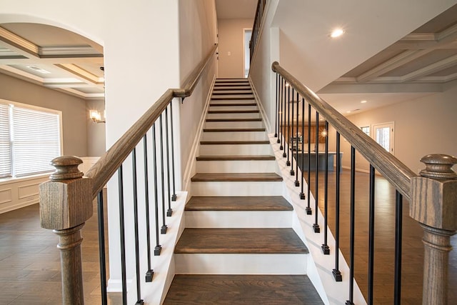 staircase with beam ceiling, crown molding, recessed lighting, wood finished floors, and coffered ceiling