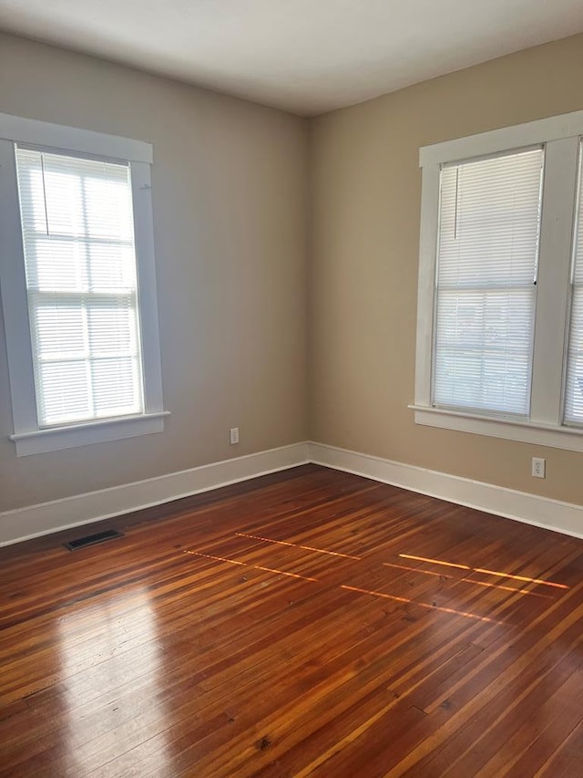 spare room with dark wood-type flooring