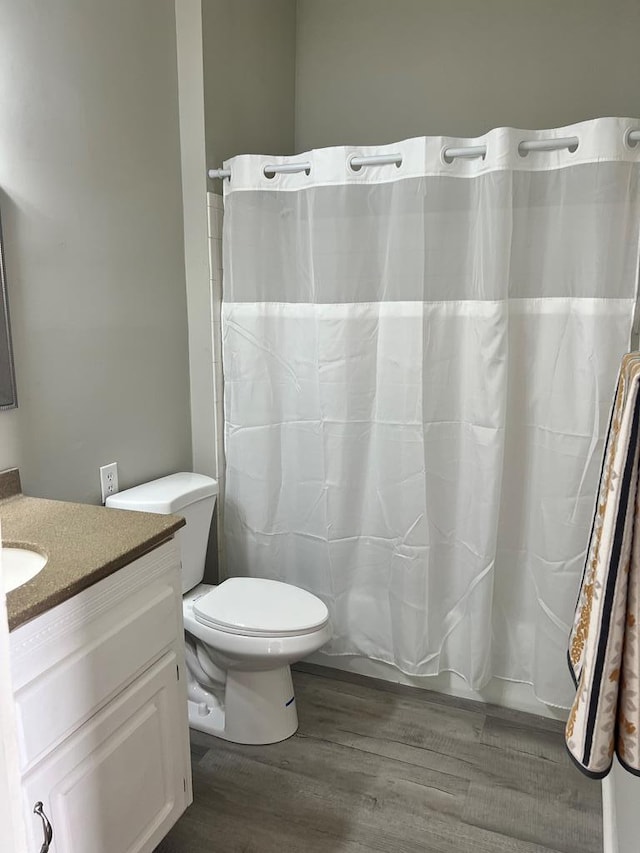 full bathroom featuring vanity, toilet, hardwood / wood-style floors, and shower / bath combo