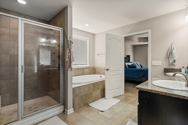 10146 Sable Oaks Dr, Midland, GA 31820 - full bath featuring ensuite bath, a garden tub, double vanity, a stall shower, and tile patterned floors