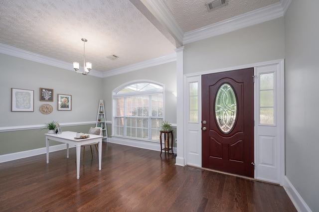 entrance foyer with a wealth of natural light, an inviting chandelier, visible vents, and wood finished floors