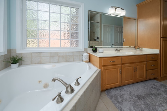 bathroom with tile patterned flooring, vanity, and a whirlpool tub