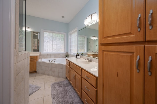 full bath with a bath, vanity, tile patterned flooring, and a shower stall