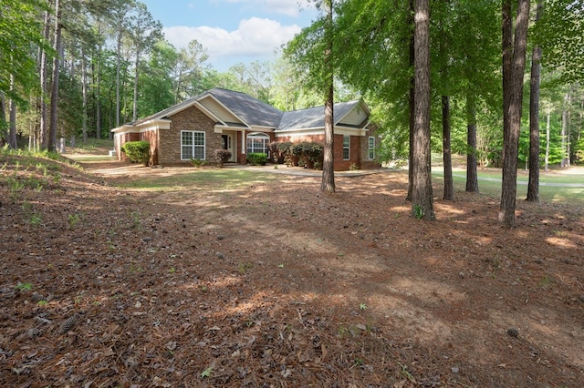 view of front of house with brick siding and driveway