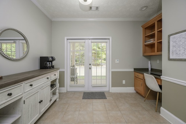 doorway to outside with built in desk, light tile patterned floors, french doors, visible vents, and baseboards