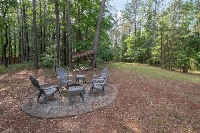 view of yard with a fire pit and fence
