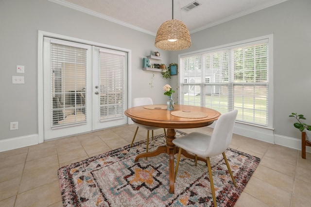 dining space with french doors, a healthy amount of sunlight, visible vents, tile patterned floors, and crown molding