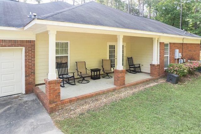 exterior space featuring roof with shingles, an attached garage, aphalt driveway, and brick siding