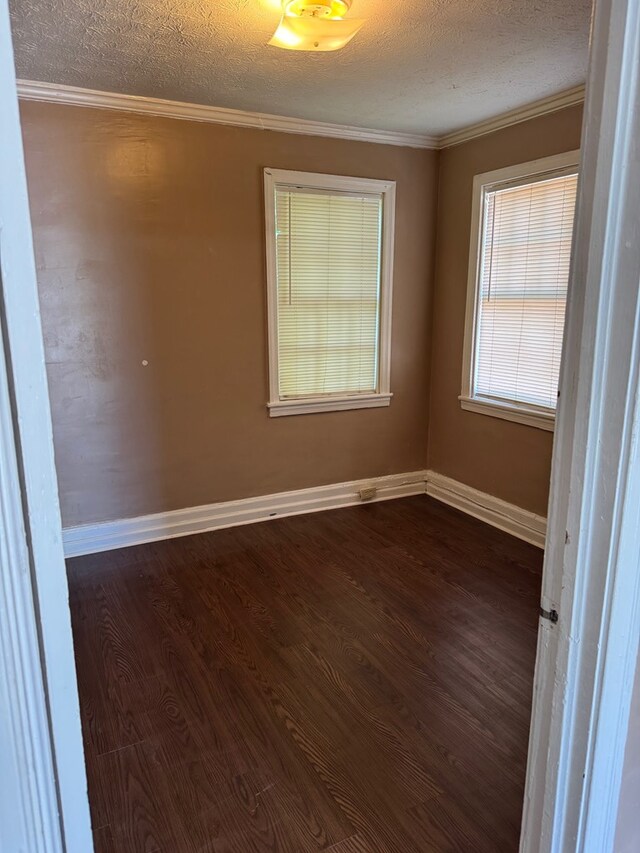 2109 12th Ave, Columbus, GA 31901 - spare room featuring crown molding, baseboards, dark wood finished floors, and a textured ceiling