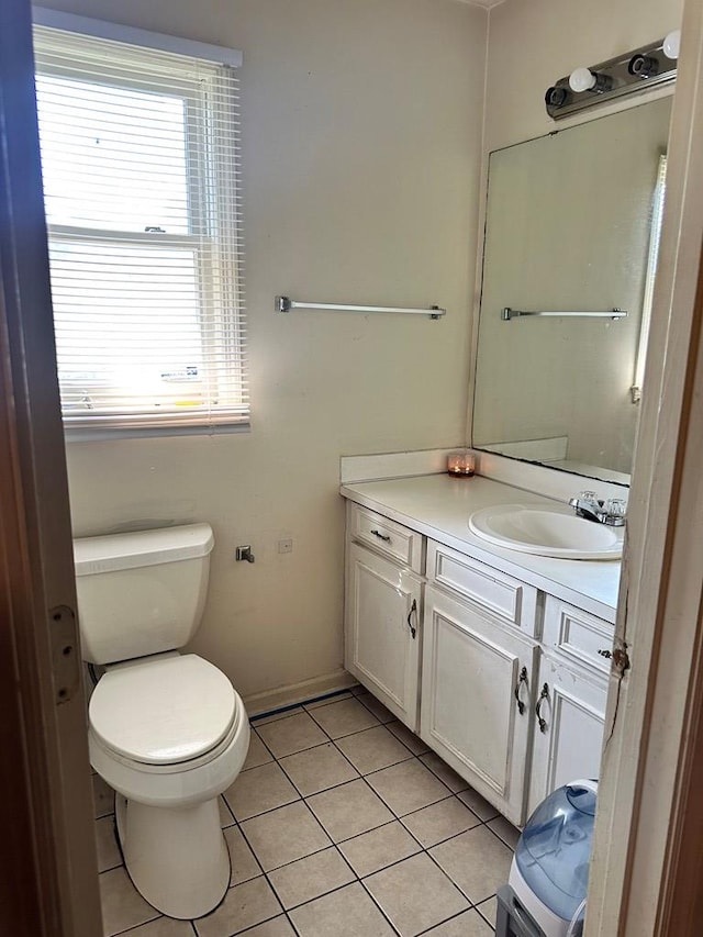 bathroom featuring tile patterned floors, vanity, and toilet