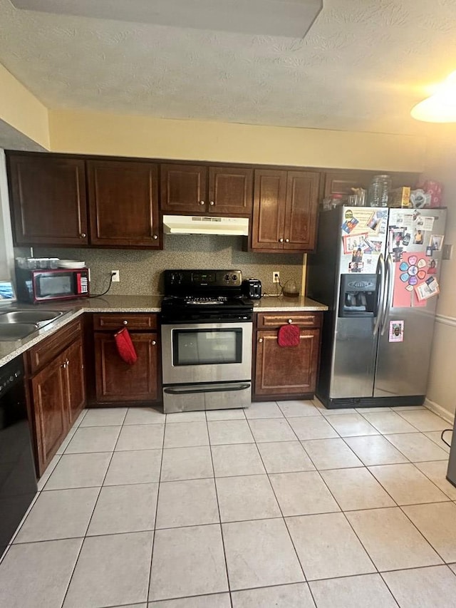 kitchen featuring light stone countertops, light tile patterned floors, sink, and black appliances