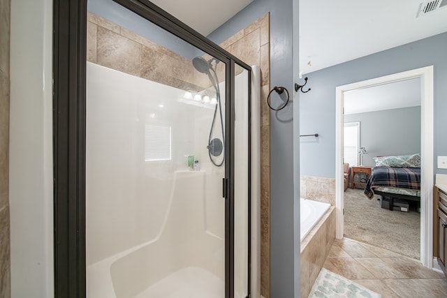9597 Yarbrough Rd, Midland, GA 31820 - bathroom with ensuite bath, a stall shower, a garden tub, and tile patterned floors