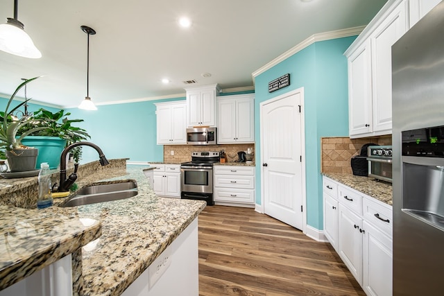 9597 Yarbrough Rd, Midland, GA 31820 - kitchen featuring stainless steel appliances, a sink, white cabinetry, tasteful backsplash, and ornamental molding